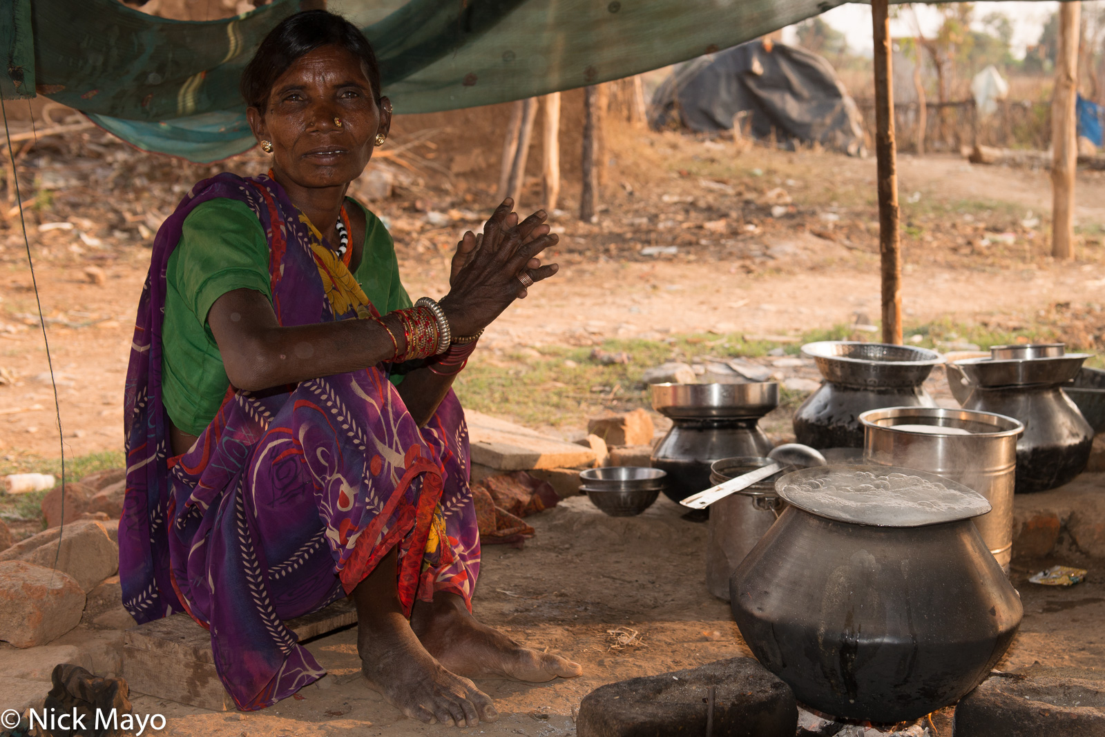 A Gond woman cooking dinner in the village of Bogla.