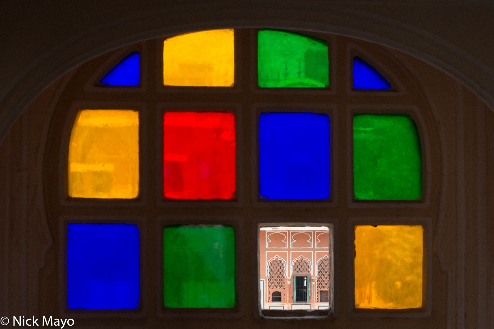 A view through a broken pane of a stained glass window at the Hawa Mahal in Jaipur.