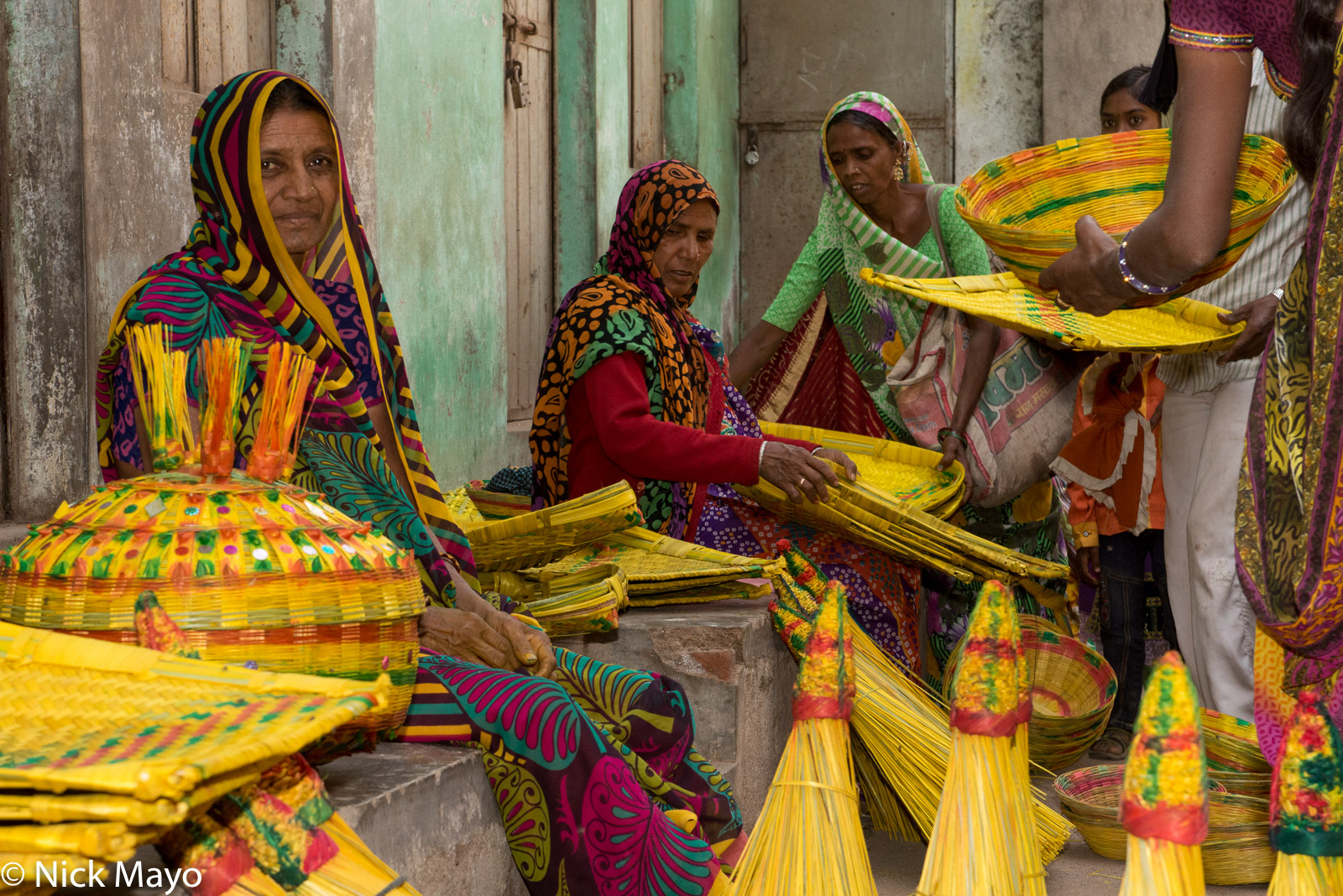 Bhangi caste women selling sweeping equipment at Kawant market.