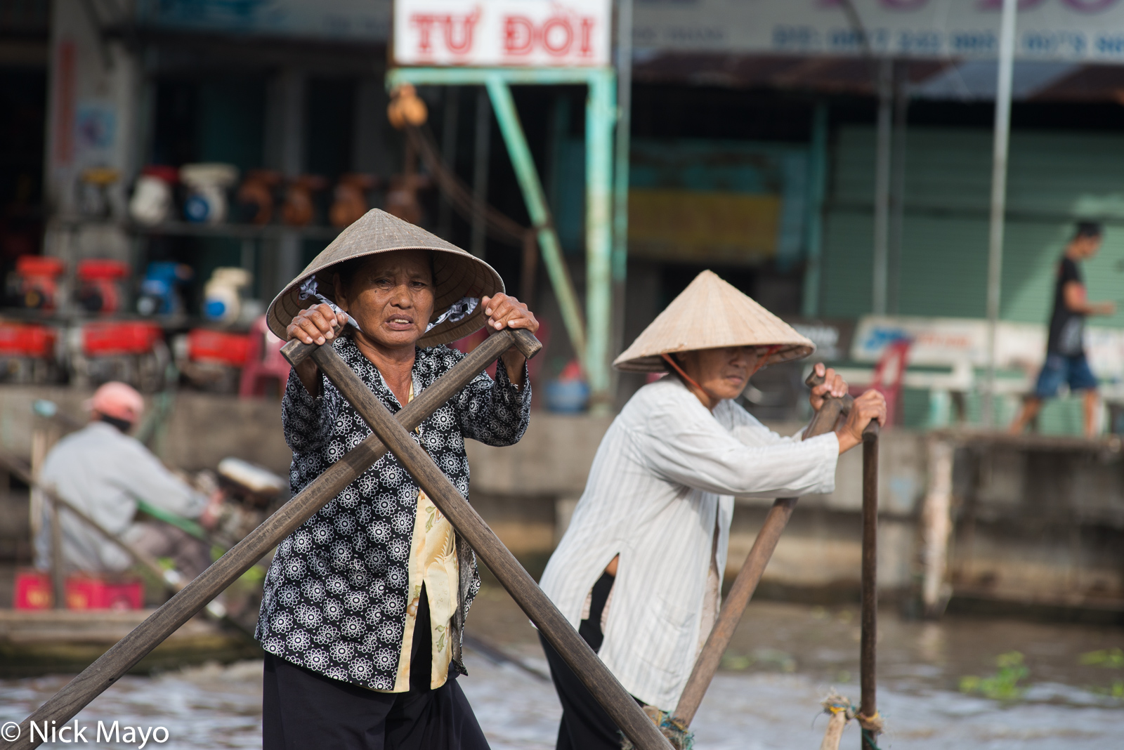 Sampan ladies in conical hats at Nga Nam in the Mekong Delta.