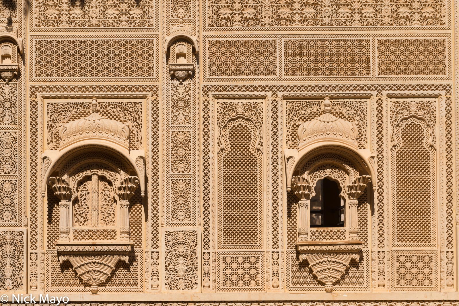 Windows in the carved wall of a Jaisalmer temple.