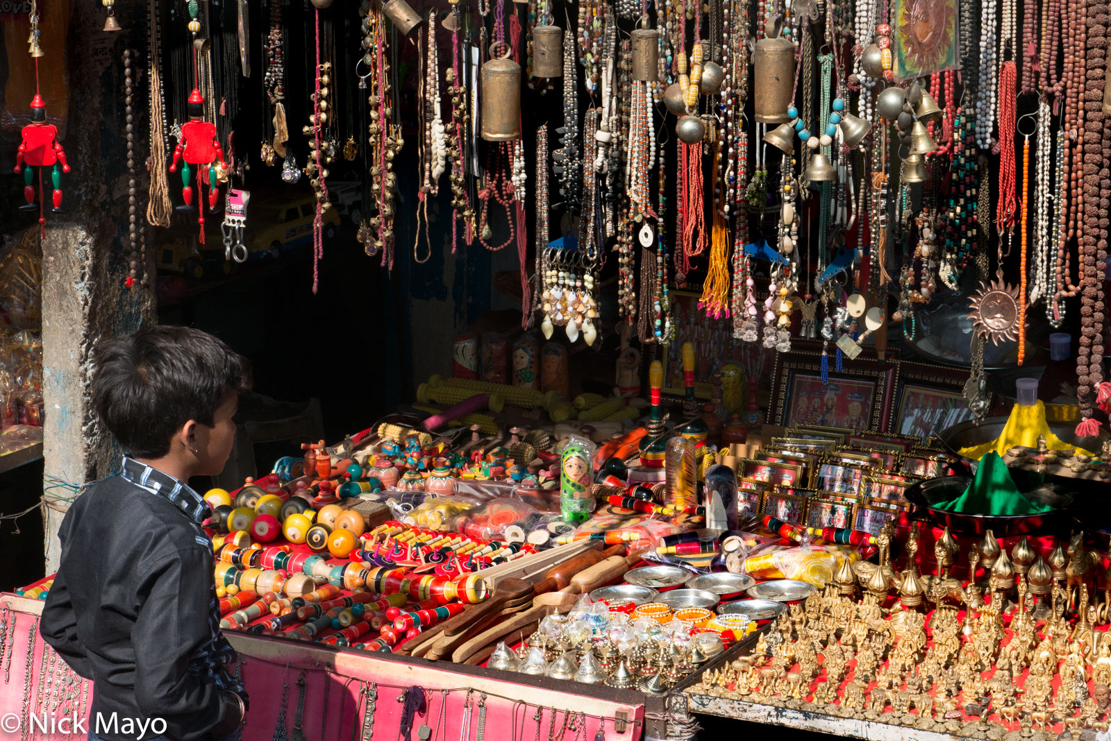 A small boy checking the goods on sale at a bazaar shop in Orchaa.