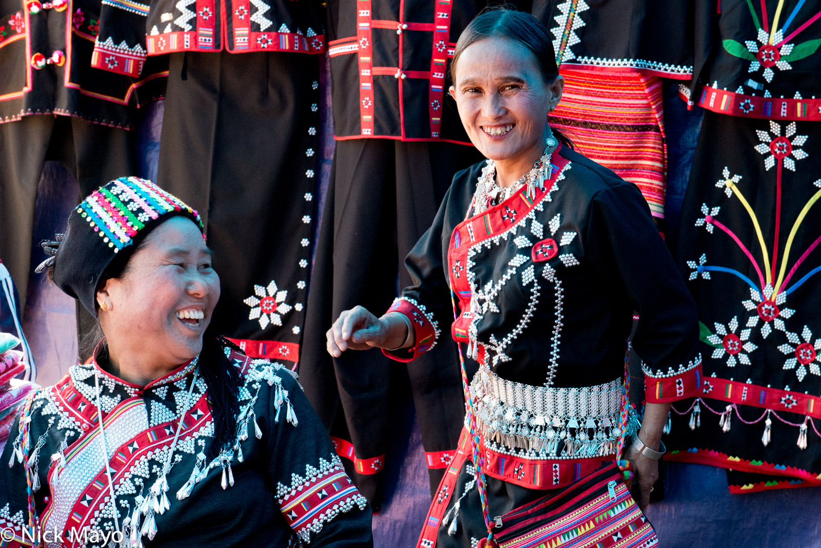 Two women in a temporary clothes store erected at a Lahu New Year festival in Kengtung.