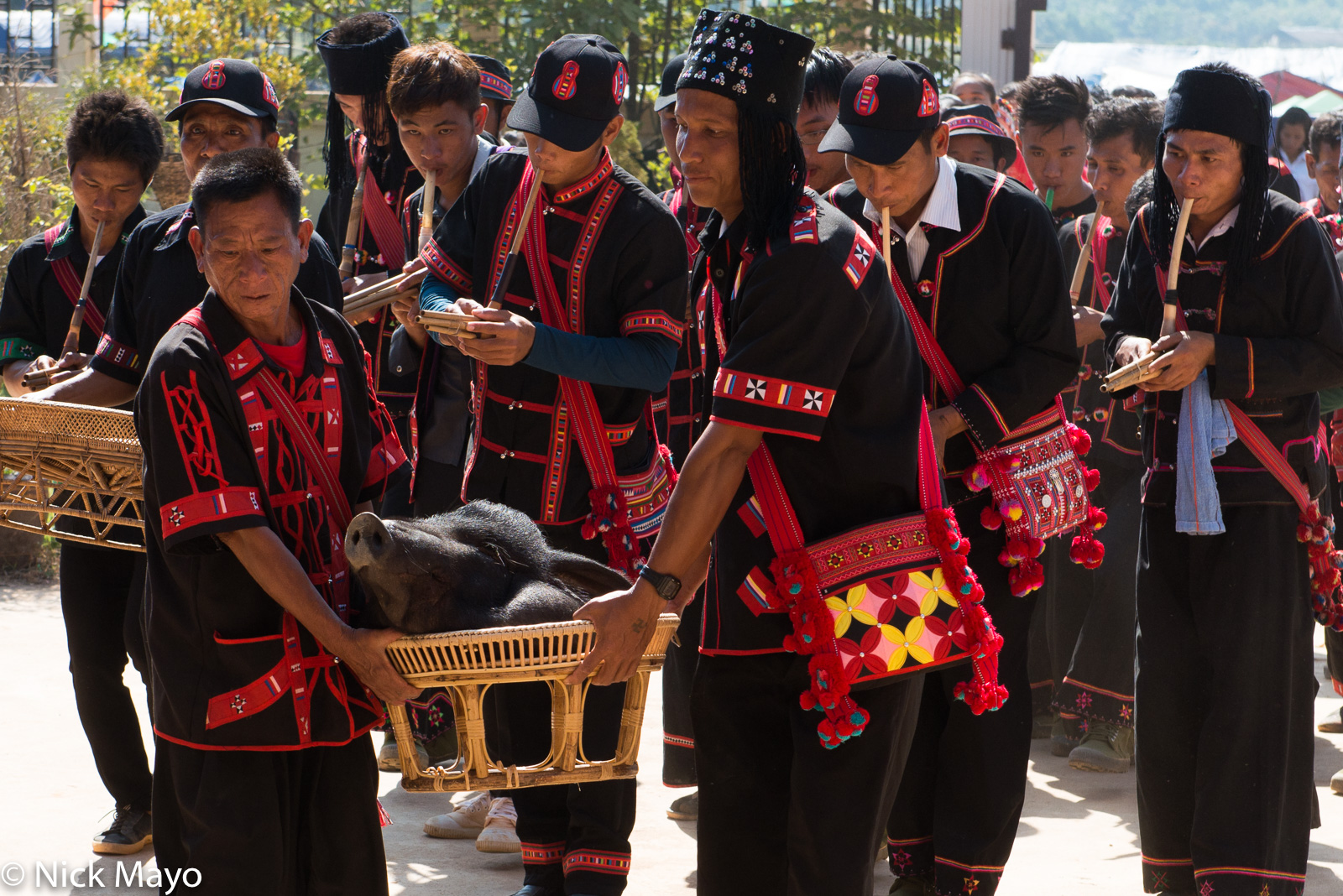 Pipers escorting the pig's head to its final destination at the conclusion of a Lahu New Year festival in Ba Bi.