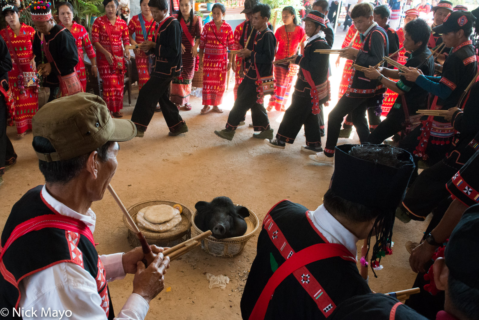 Pipers circling the pig's head during the final ritual of a Lahu New Year festival in Ba Bi.