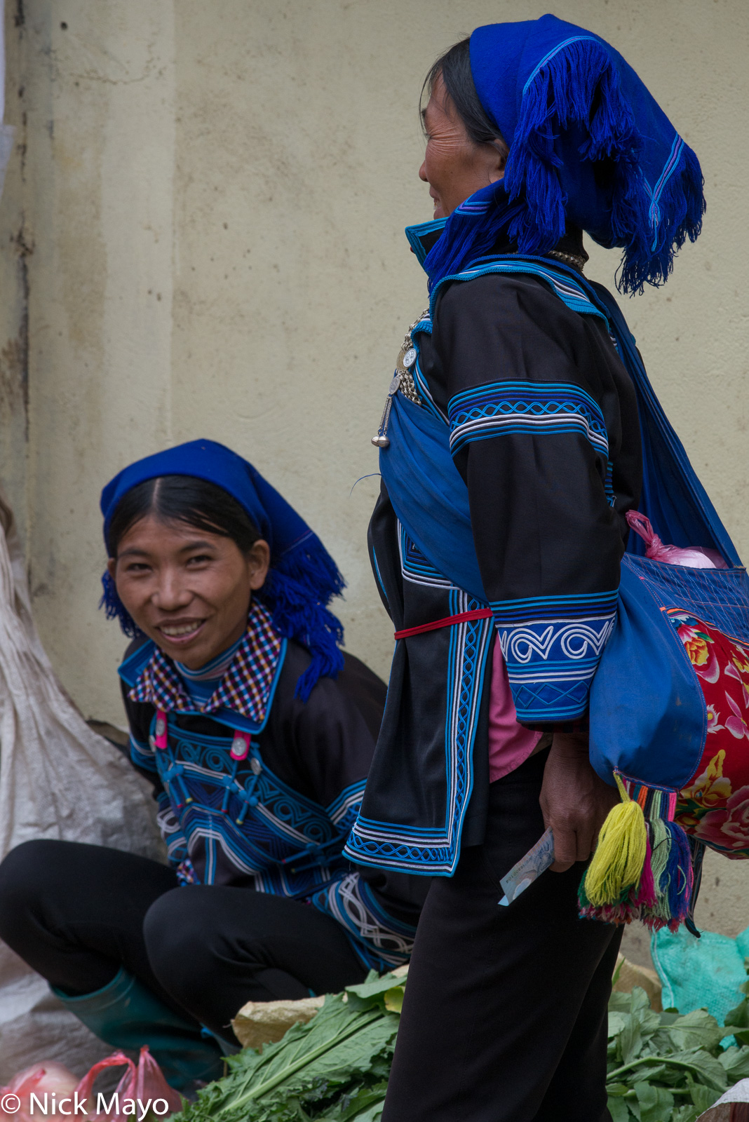 Two Hani women selling vegetables at the New Year market in Muong Hum.