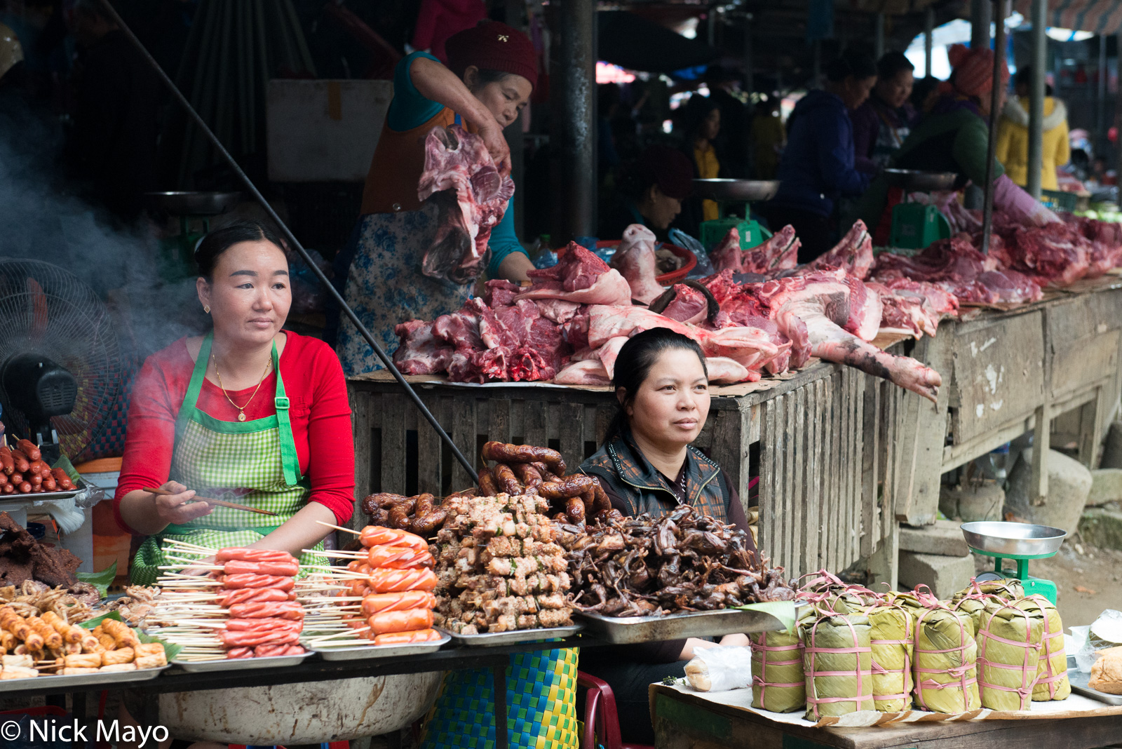 Women selling meat at Muang So market.