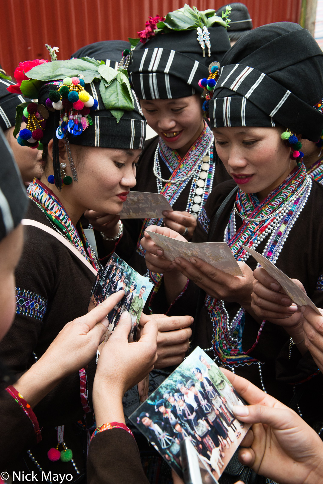 Lu women looking at photographs taken 12 years earlier in their village in the Nam Ma valley.