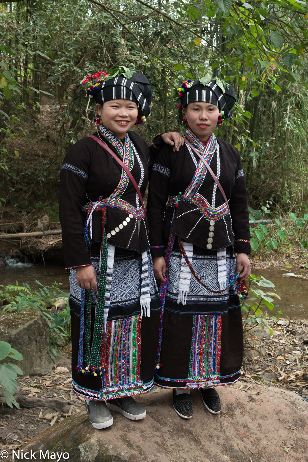 Two Lu girls posing for a photograph at a New Year festival in a Nam Ma valley village.