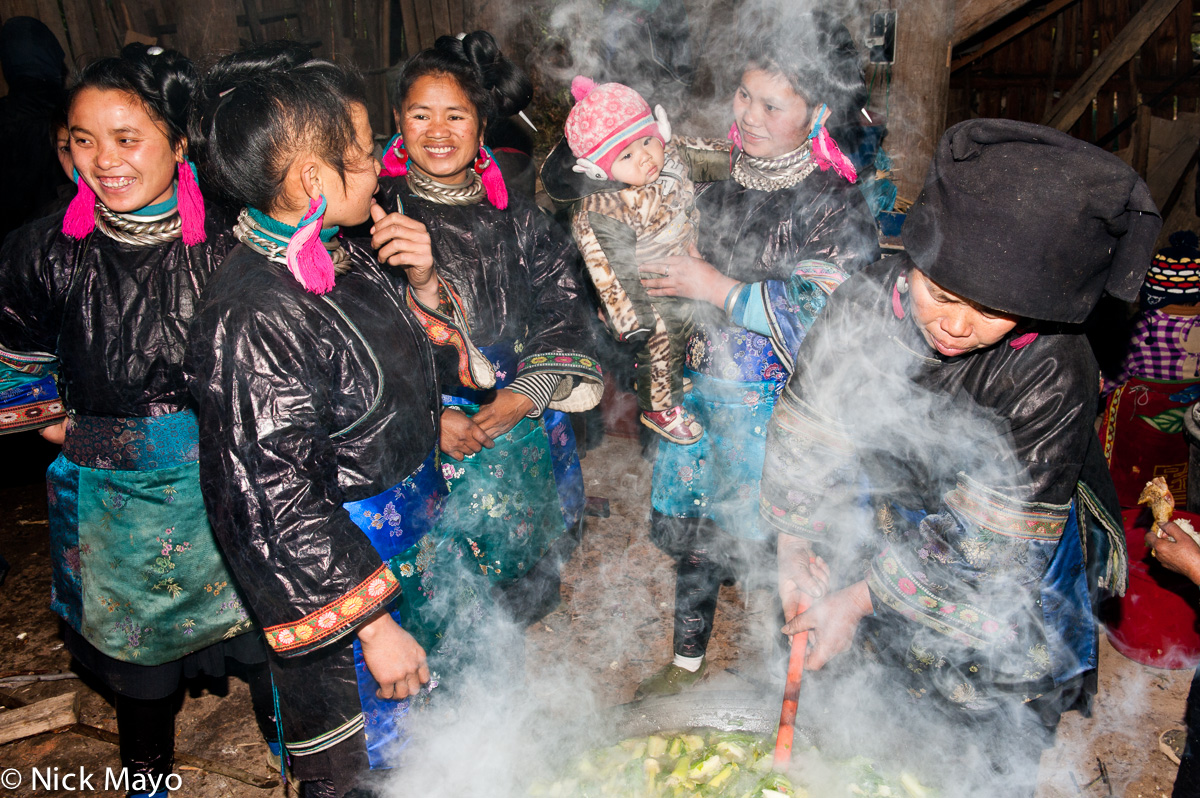 Women from Miao Gu village steaming vegetables for a baby shower lunch.