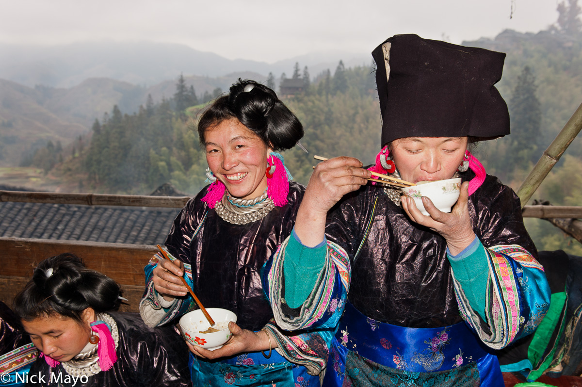 Women from Miao Gu village eating at a baby shower lunch.