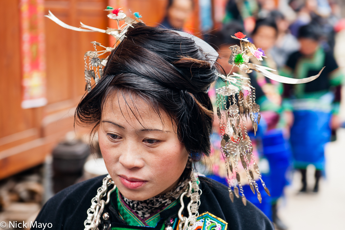 A Dong woman wearing an elaborate hairpiece at a wedding in Shao Dong village.