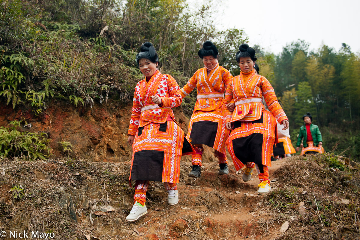 Miao woman on their way to a wedding in Zaibang village.