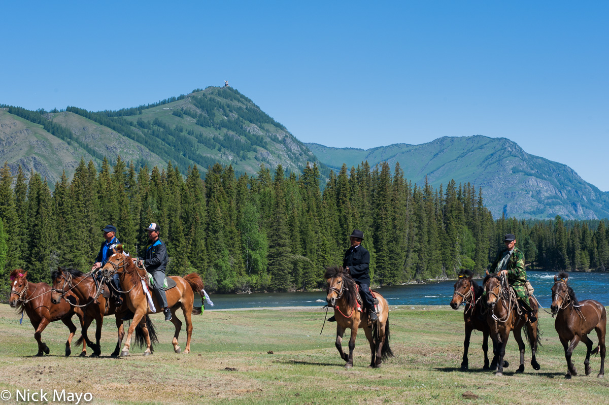 Tuva horsemen riding to a festival at Kanas.