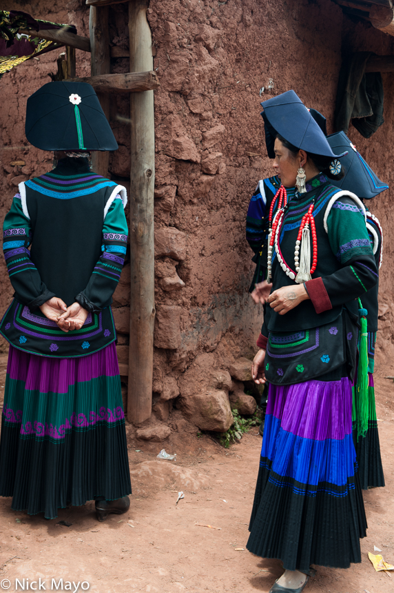 Yi women outside the house of the deceased at a funeral in Mi Shi Qing Mo in Daliangshan.