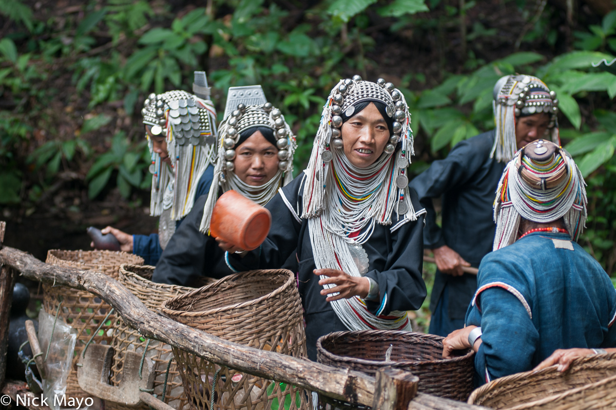 Akha (Hani) women with their backstrap baskets fetching water from the spring in the village of Hoi Yang II.