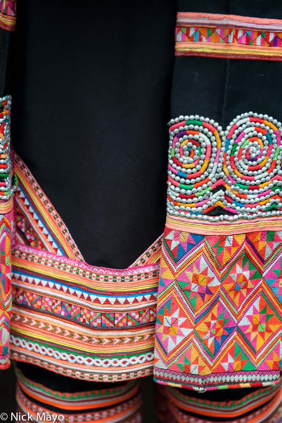 Embroidered end pieces and leggings worn by a Hani woman in the village of Majie.
