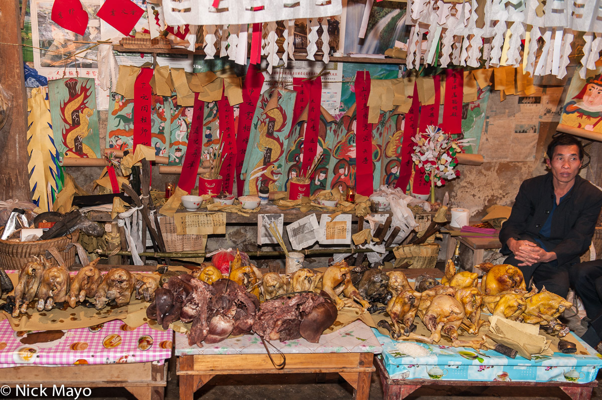 A shrine, set up for a dujie in the Yao village of Ku Ju Jie, with meat symbolically placed before it.