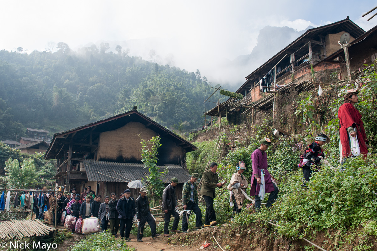 A dujie procession, led by a san mienh (Yao priest), through the village of Ku Ju Jie.