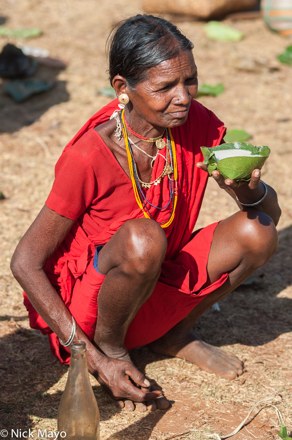 A Maria woman of the Gond ethnicity about to drink mahuli from a leaf cup at Madum market.