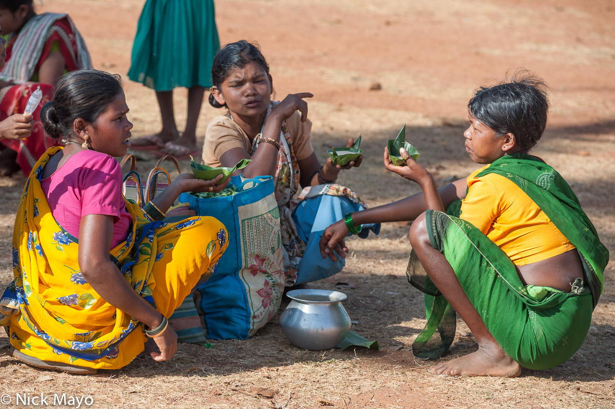 Three Maria women of the Gond ethnicity about to drink from a container of mahuli at Madum market.