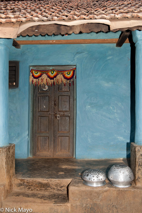 A doorway set in a blue washed wall in the village of Pajil.