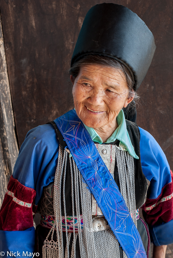 A Yellow Lisu woman, in her traditional breastpiece and hat, at the village of Loi Lom.