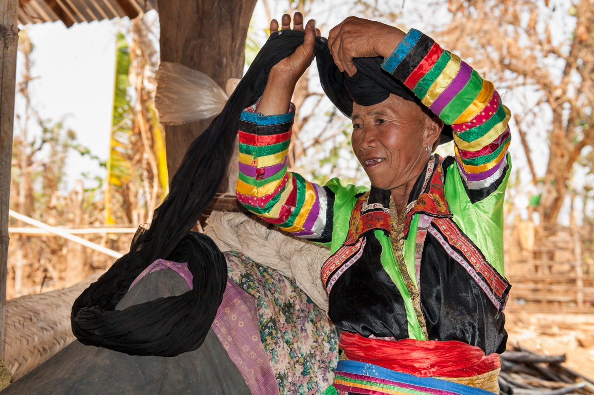 A White Hmong (Miao) woman wrapping her turban in Mang Gon village.