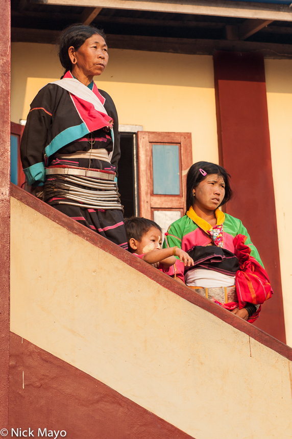 Two Palaung women in traditional dress and waist hoops at a shinbyu (novitiation ceremony) in the village of&nbsp;Loilom.