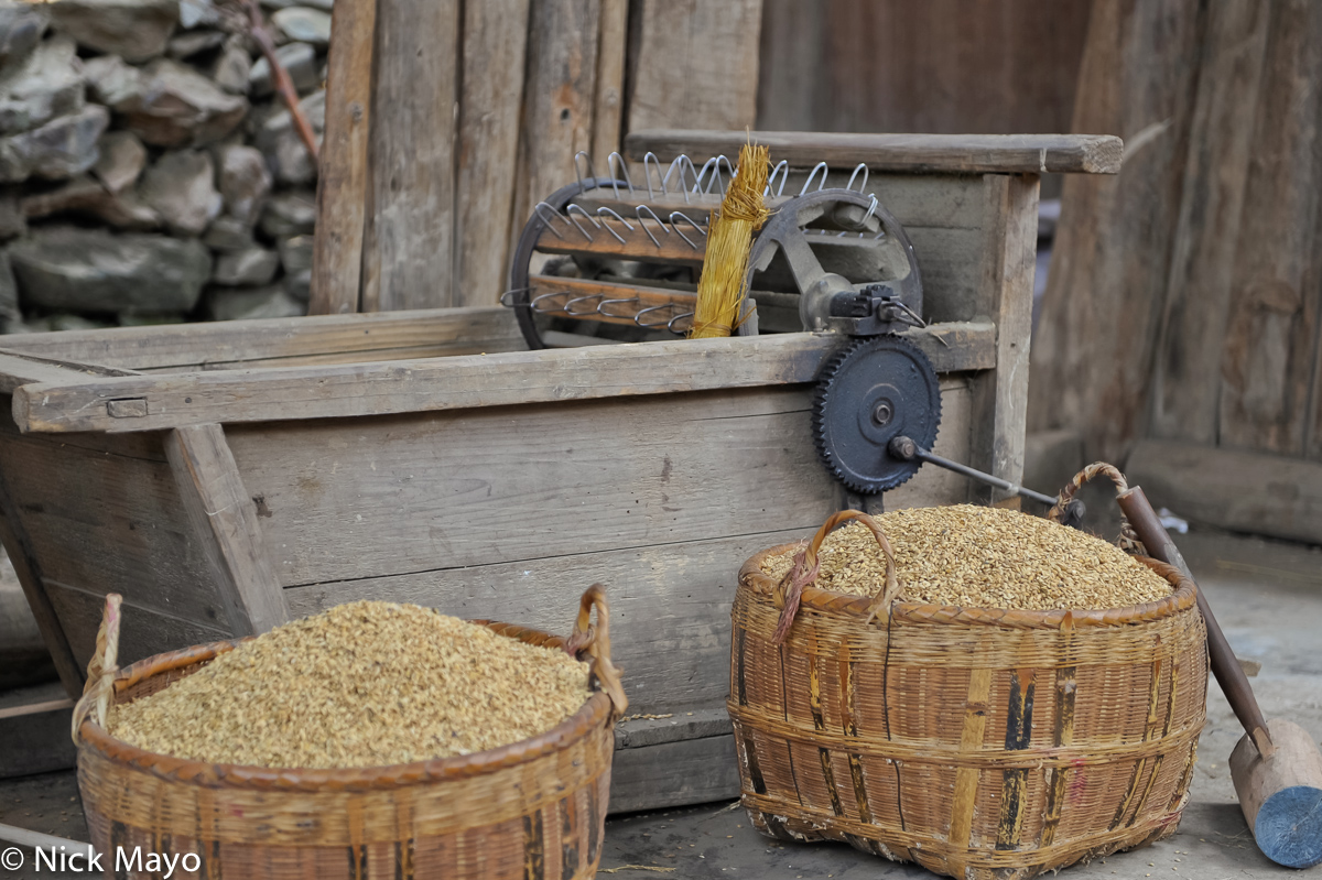 A thresher, paddy rice and mallet in the Dong village of Wuei.