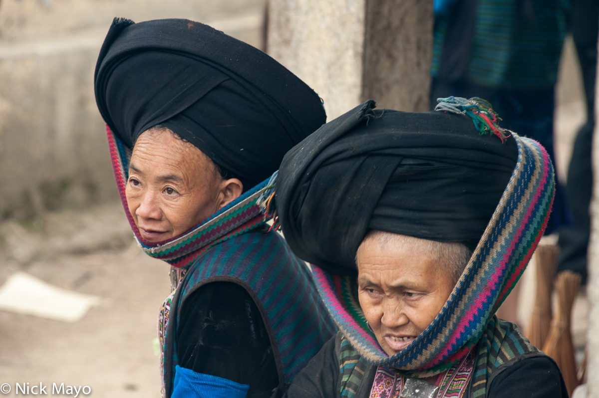 Two Dao Ta Pan (Yao) women in their traditional hats at Lung Phin on market day.