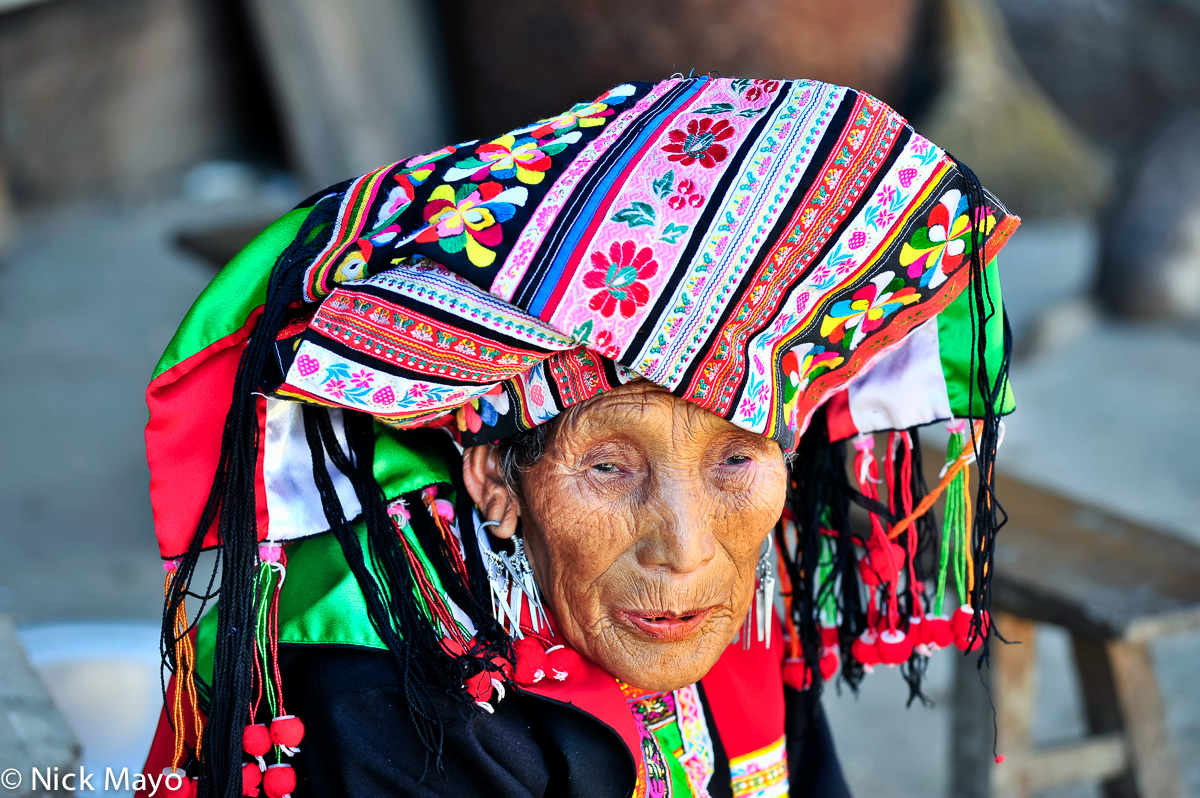 A Lisu woman from Huang Lien He village wearing an intricately embroidered turban.