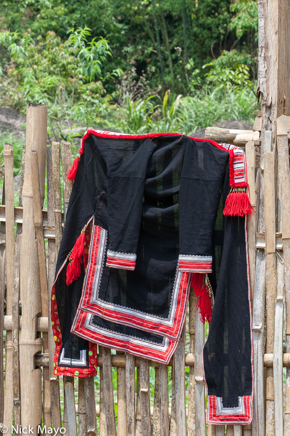 A Red Dao (Yao) jacket hung on a fence in the village of Nam Son.