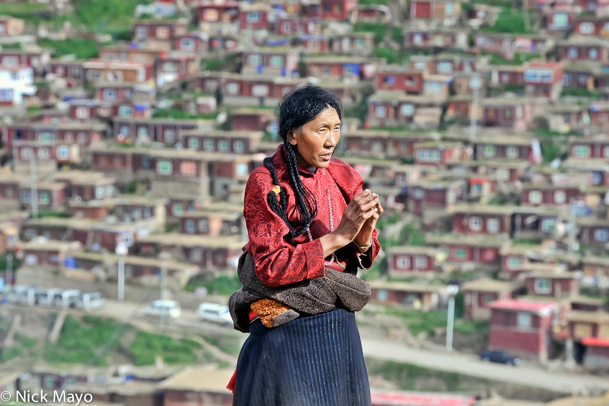 A Tibetan woman praying at the Larung Gar academy in Sertar.