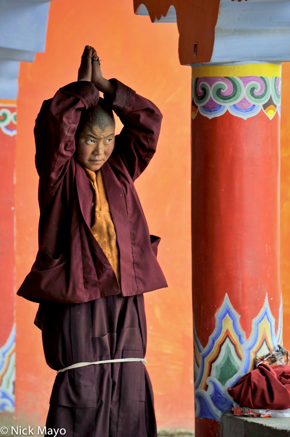 A Tibetan nun praying at the Larung Gar academy in Sertar.