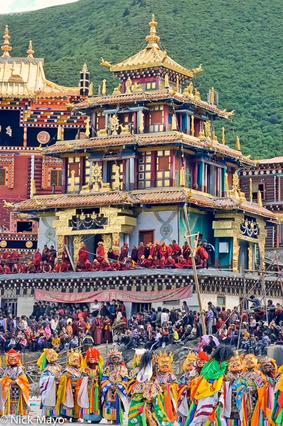 A procession of masked Tibetan monks during a festival at the Katok monastery.