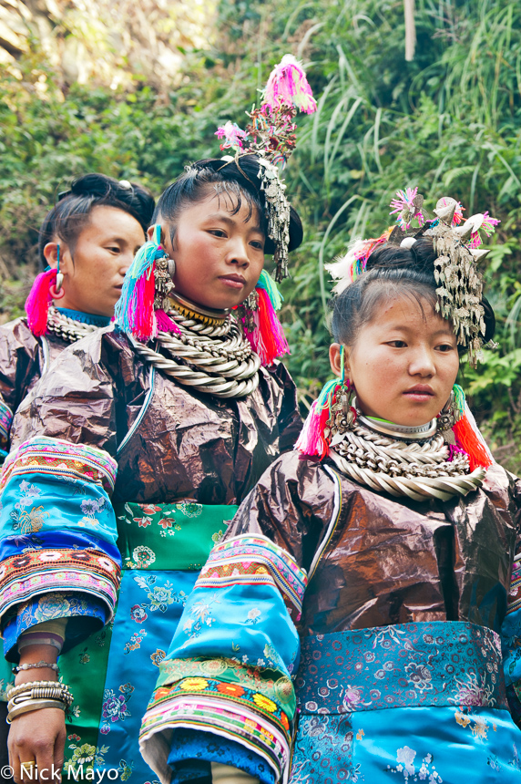 A Miao bride and bridesmaid making their way to a wedding in the village of Gui Lai. 
