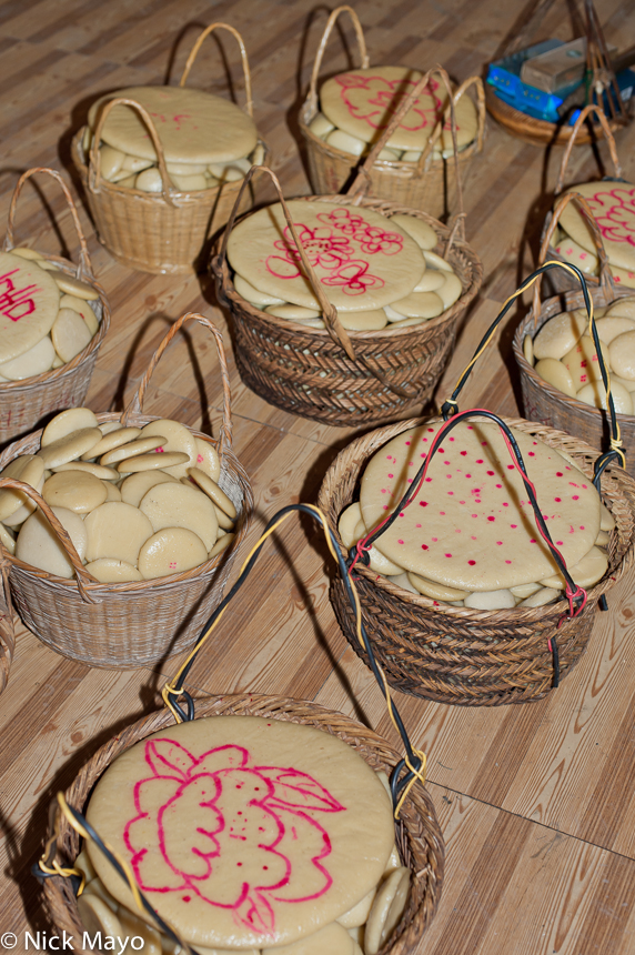 Rice cakes in wicker containers to be given as gifts at a baby shower in Ba Shu.