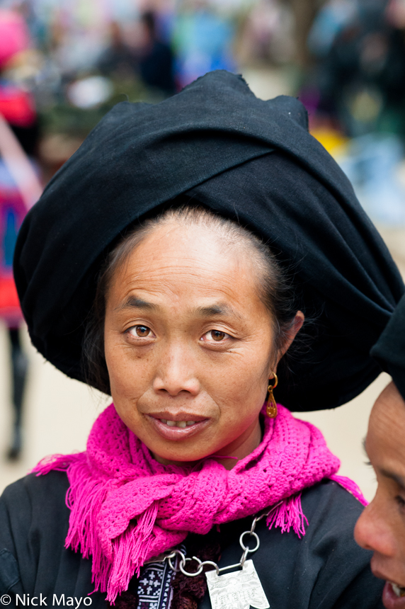 A Butuo Yao woman from Vietnam in a black turban at Nafa market.