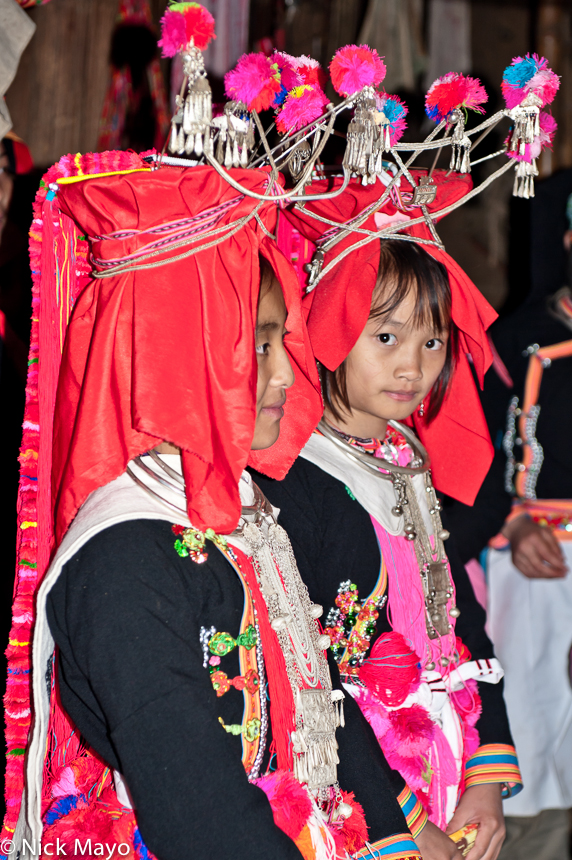 Bridesmaids, wearing traditional wedding hats and heavy necklaces & breastpieces, at a Yao wedding in Hui Yang Lao Zai. 