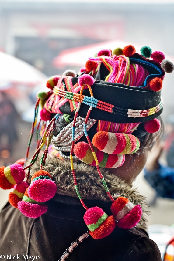 A brightly coloured woollen hat worn by a Hani woman in Pinghe.