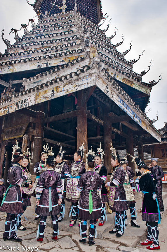 A group of Dong girls waiting by a drum tower for their turn to sing at a Xiaohuang festival.