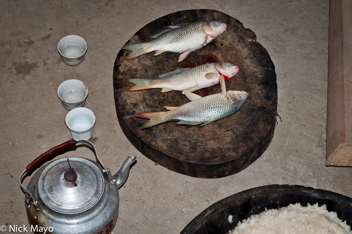 Three fish and a kettle of rice wine for use during a Miao wedding ceremony in Cenzui.