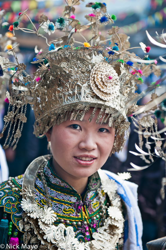 An unmarried Dong girl wearing a crown headdress at a New Year festival in Yang Dong.