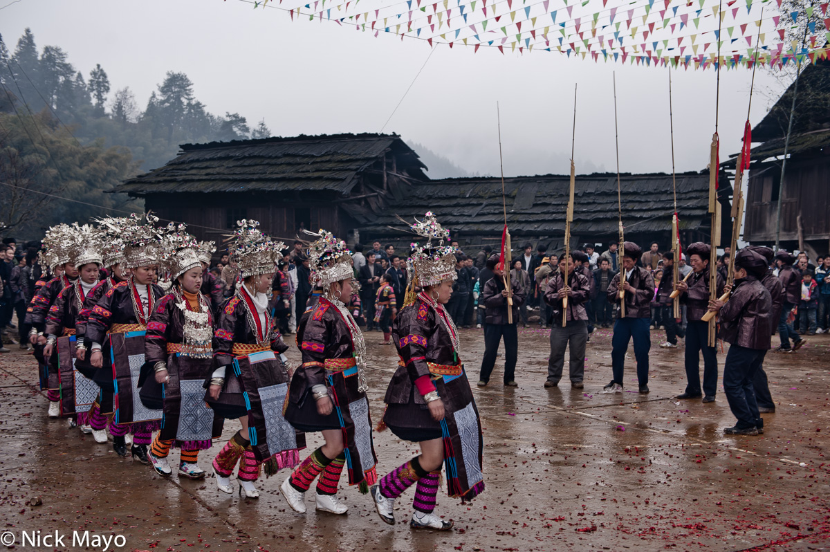 Unmarried Miao girls circling lusheng pipers at a New Year festival in Ba Shu.