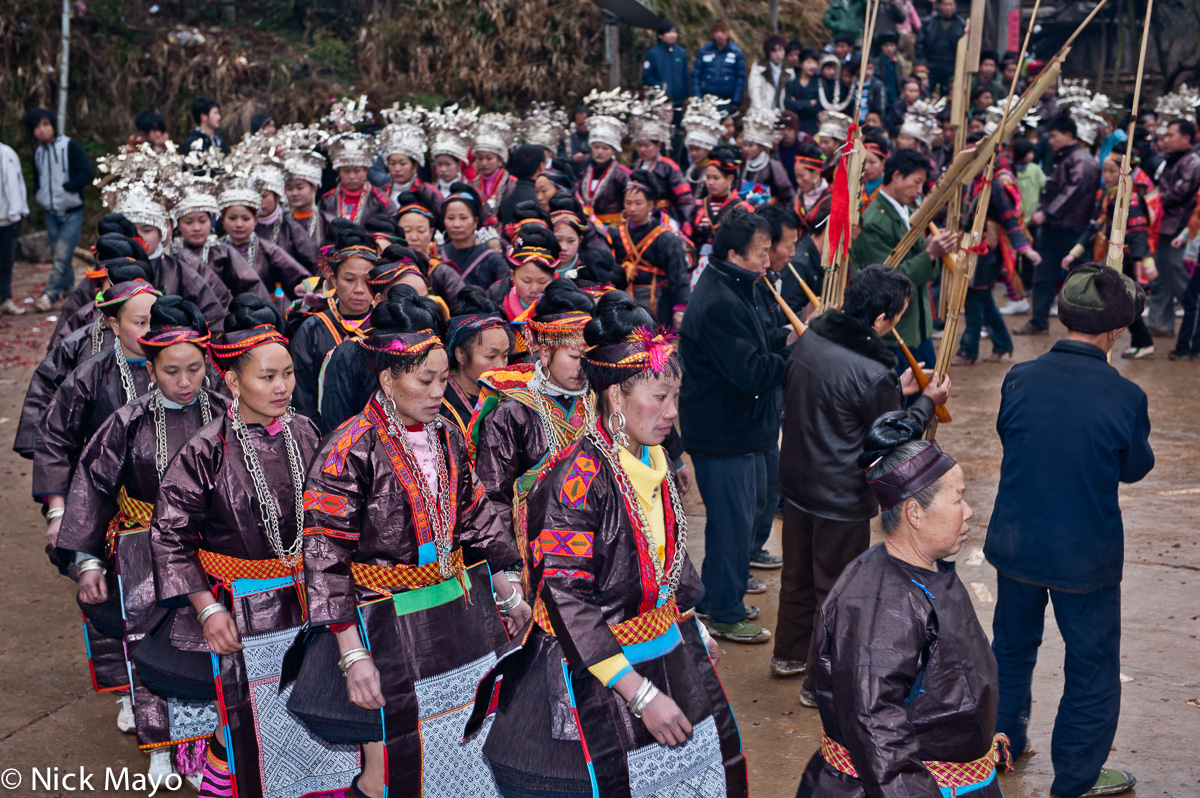 Married mini skirted Miao women circling the lusheng pipes at a New Year festival in Ba Shu.