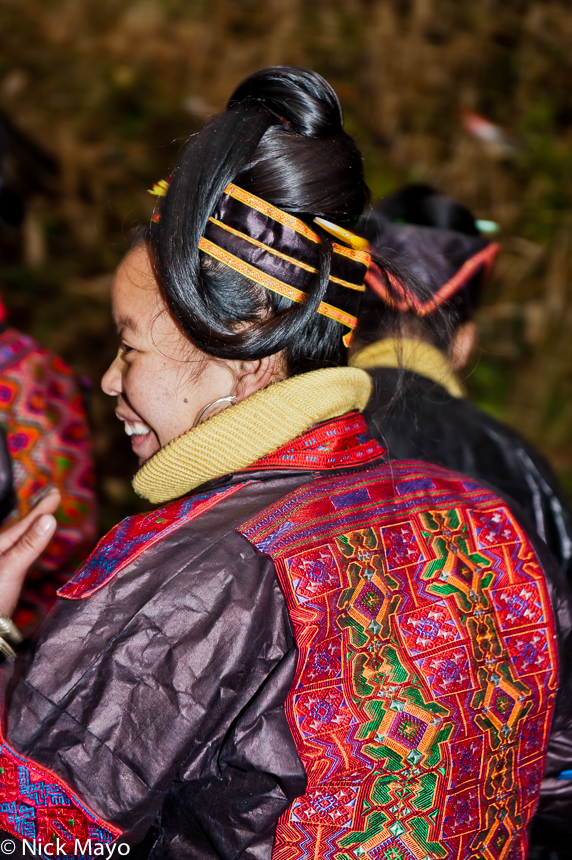 A highly ornate hairstyle worn by a Miao woman at a festival in Ba Shu.