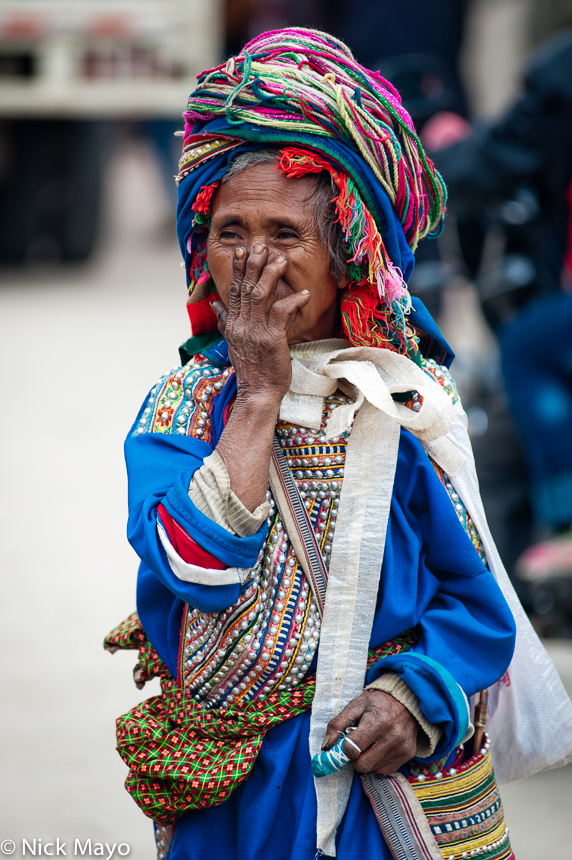 A traditionally dressed Lahu woman from Nanmei with an embroidered shoulder bag.