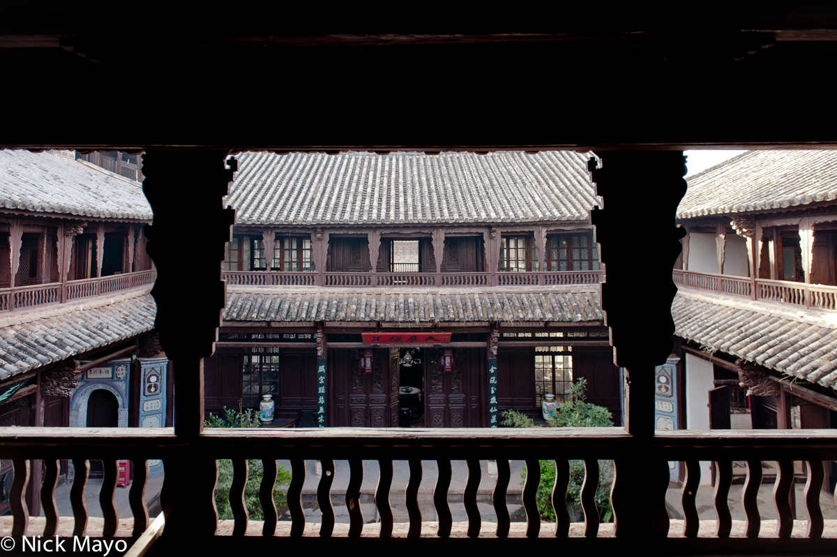 The interior courtyard, surrounded by balconies topped by grey tiled roofs, of an officials' wooden residence in the historic...