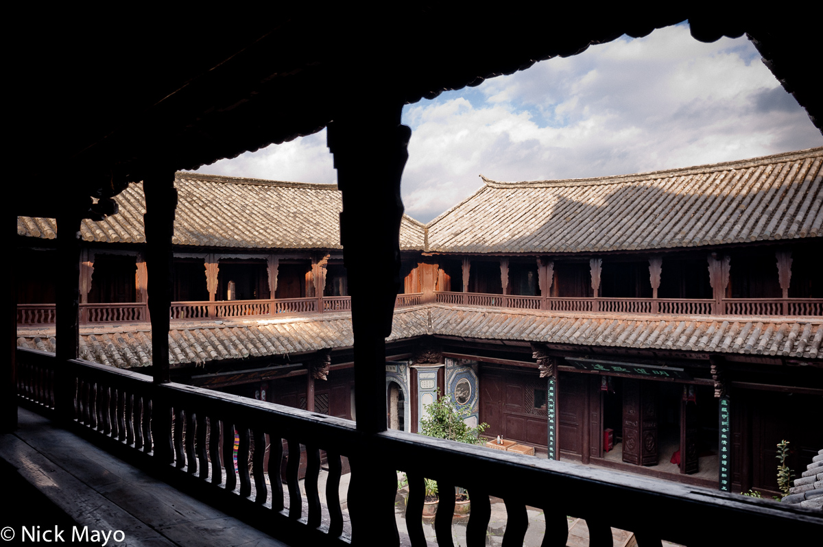 Balconies, topped by grey tiled roofs, surrounding a central courtyard in an officials' wooden residence in the historic Muslim...